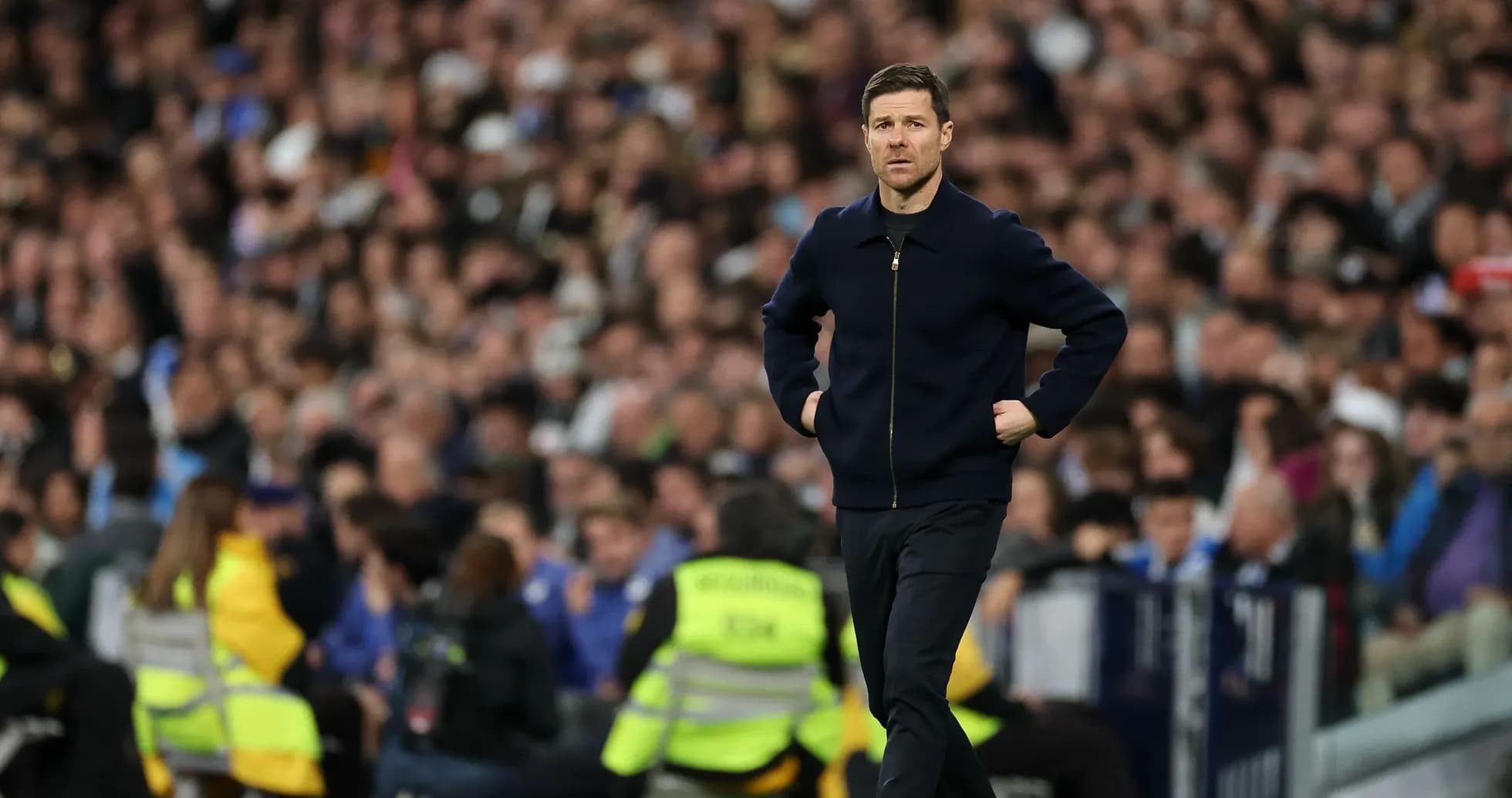 Manager walking along the touchline during match