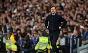 Manager walking along the touchline during match