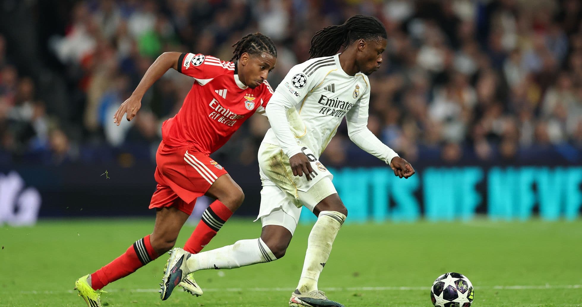 Real Madrid player dribbling past Benfica defender