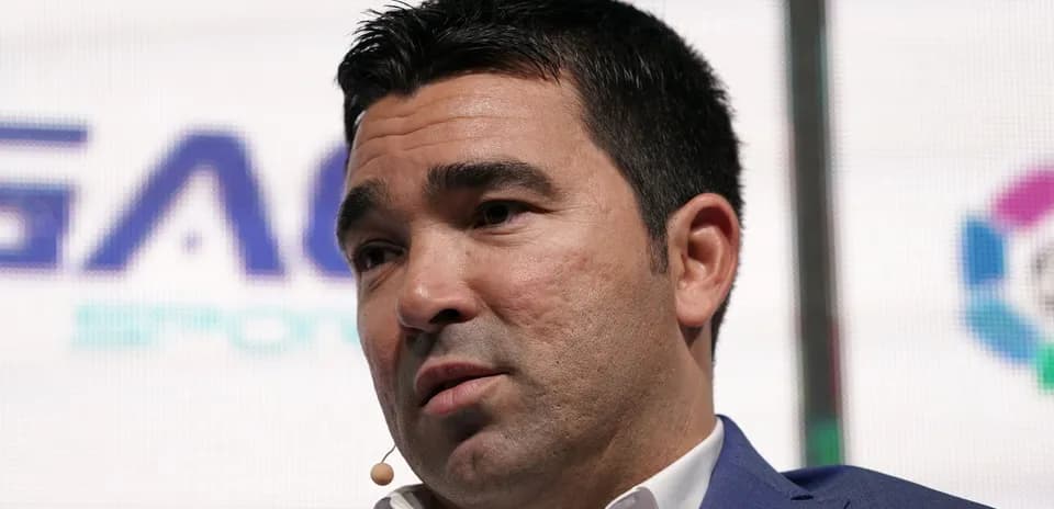 Man speaking at event with microphone attached