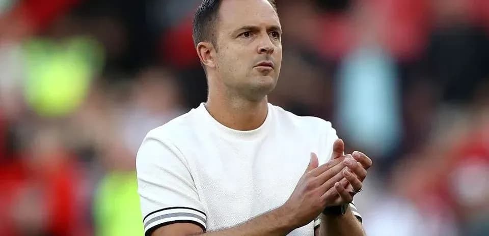 Coach applauding during a match on the sidelines