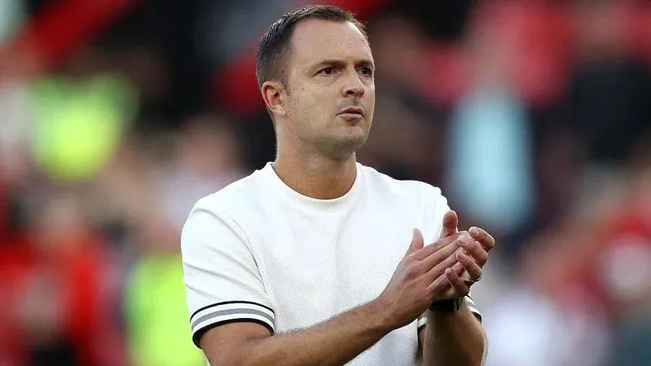 Coach applauding during a match on the sidelines