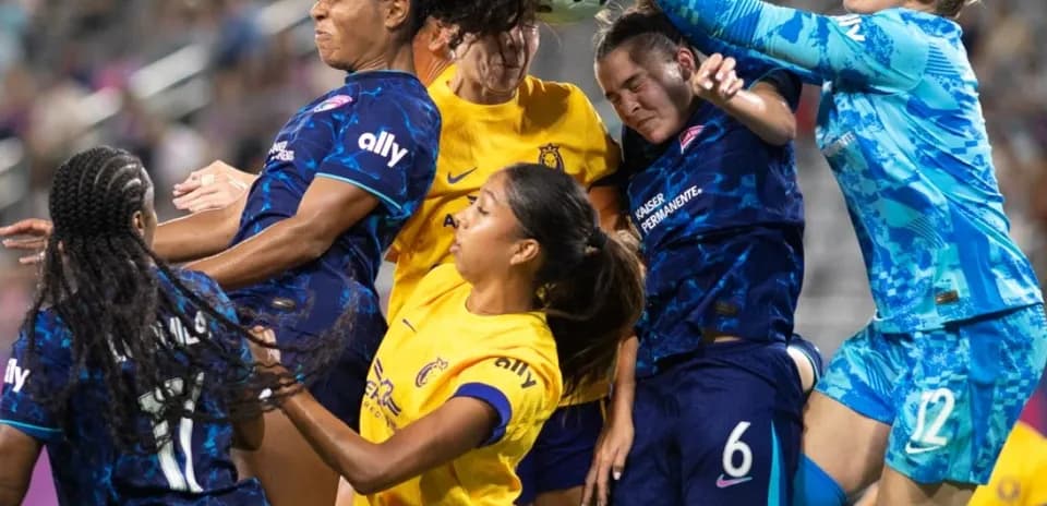 Players contesting for the ball during match