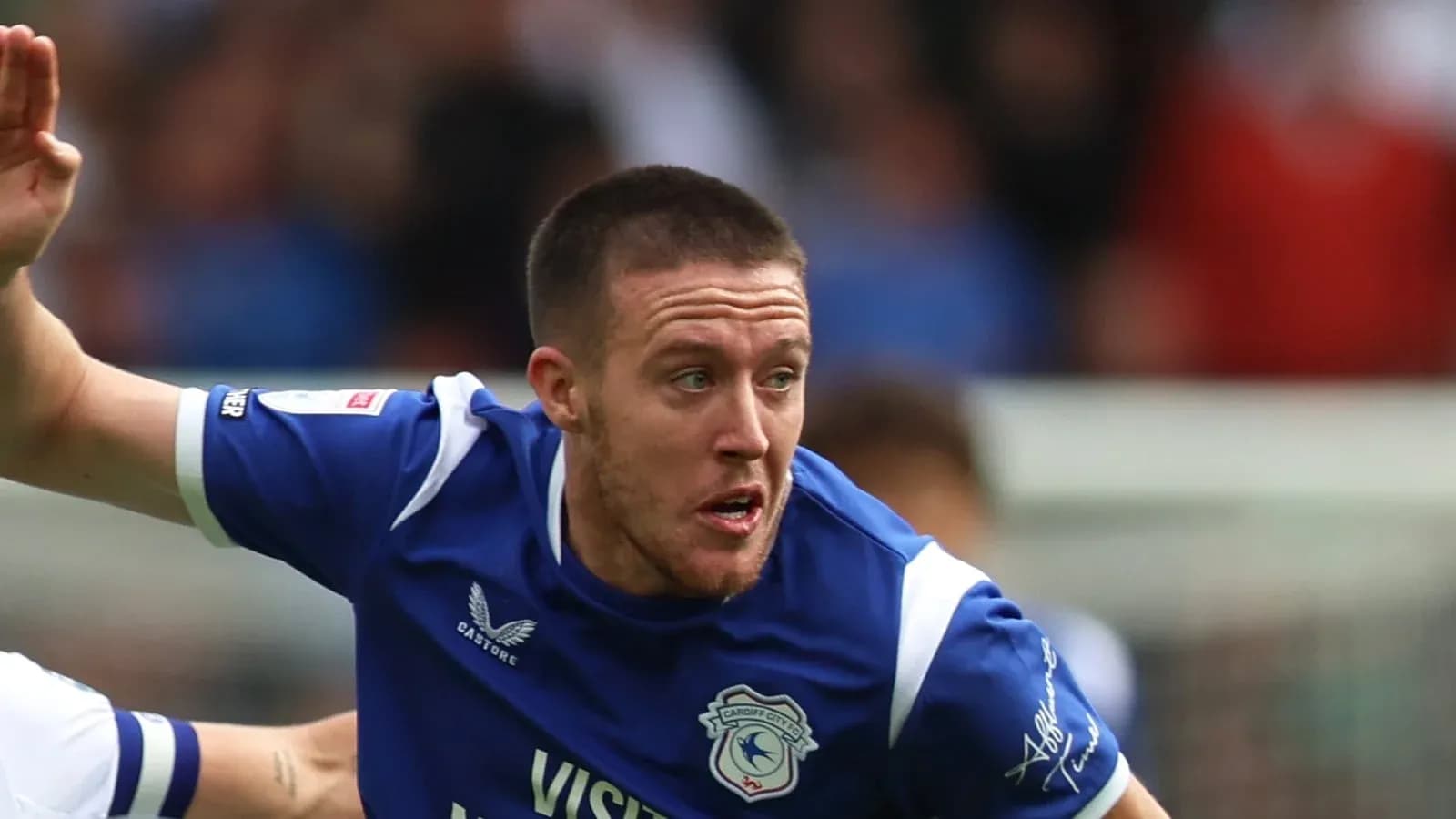 Player in blue jersey during football match action