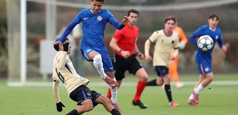 Player from Chelsea evades tackle during match