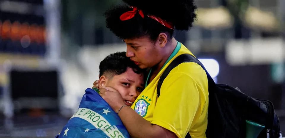 Two fans wrapped in Brazil flag at event