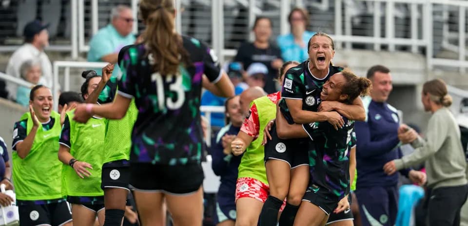 Players celebrating during Racing Louisville match
