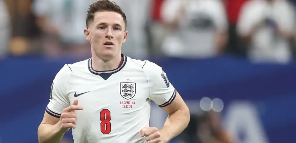 Player in England jersey running on the field