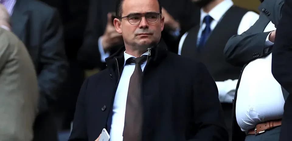 Man in suit observing event from VIP area
