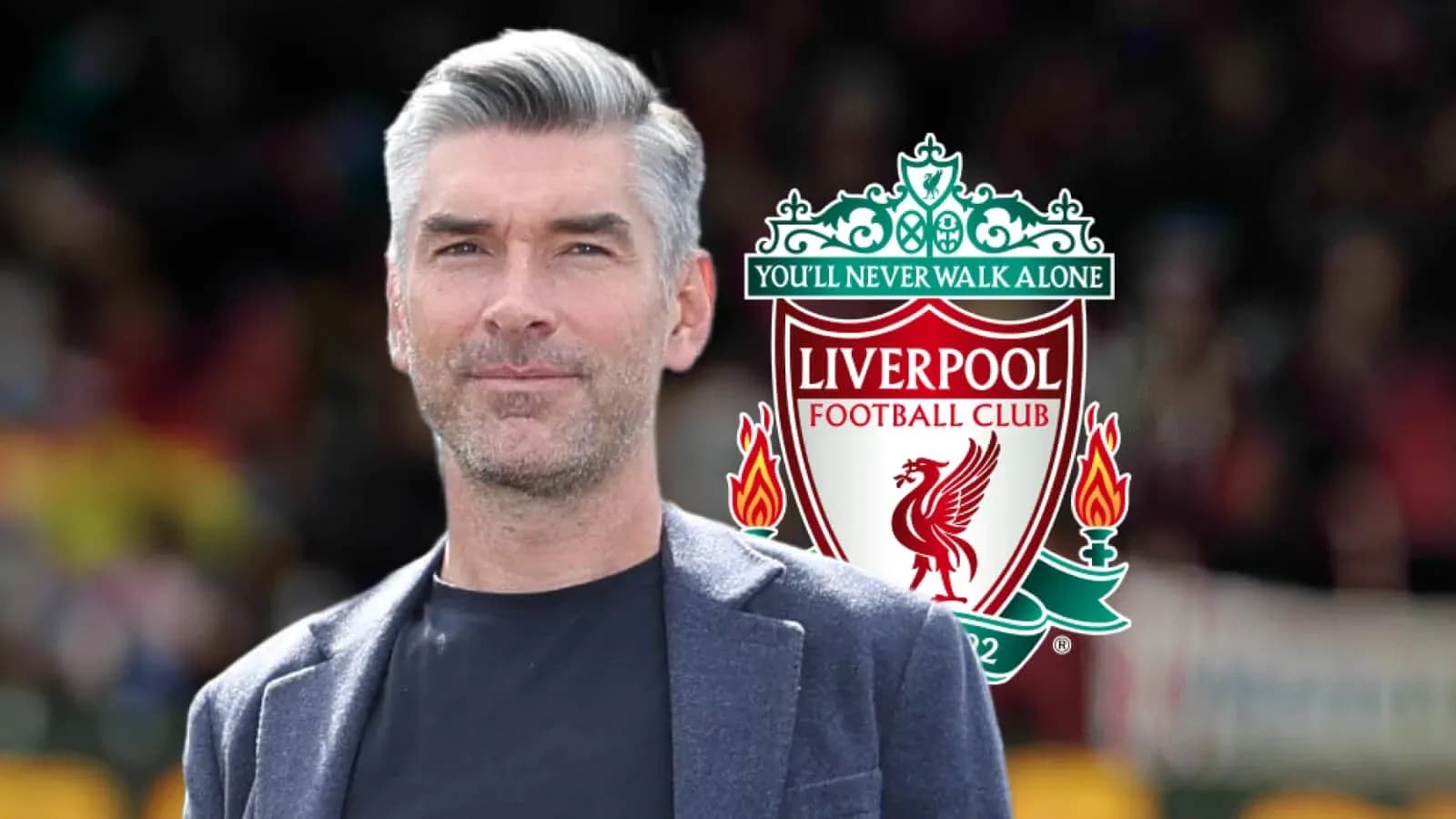 Person standing in front of Liverpool FC logo