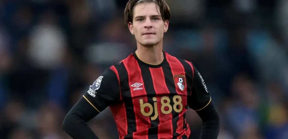 Bournemouth player in black and red jersey on field