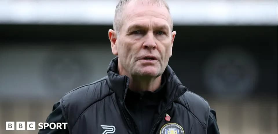 Manager in black jacket at training ground