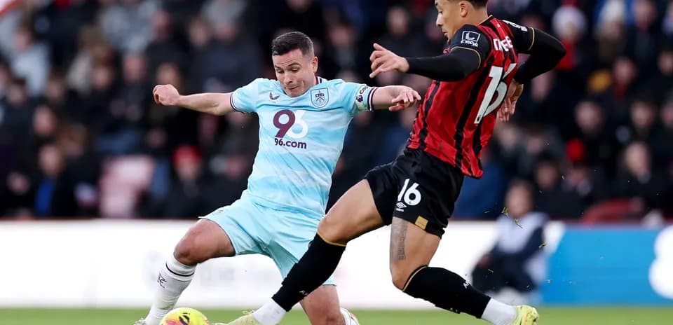 Burnley player tackling Bournemouth opponent