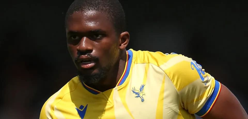 Player in yellow jersey running on the pitch