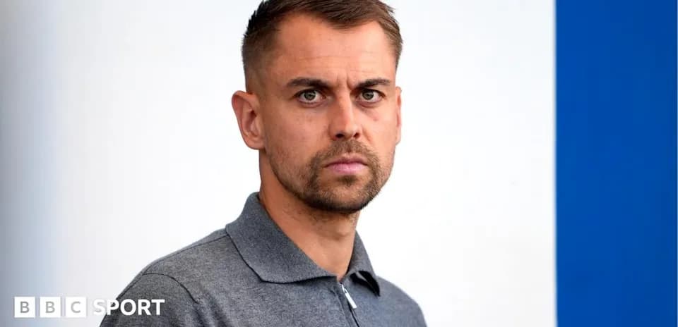 Man in gray polo shirt against blue background