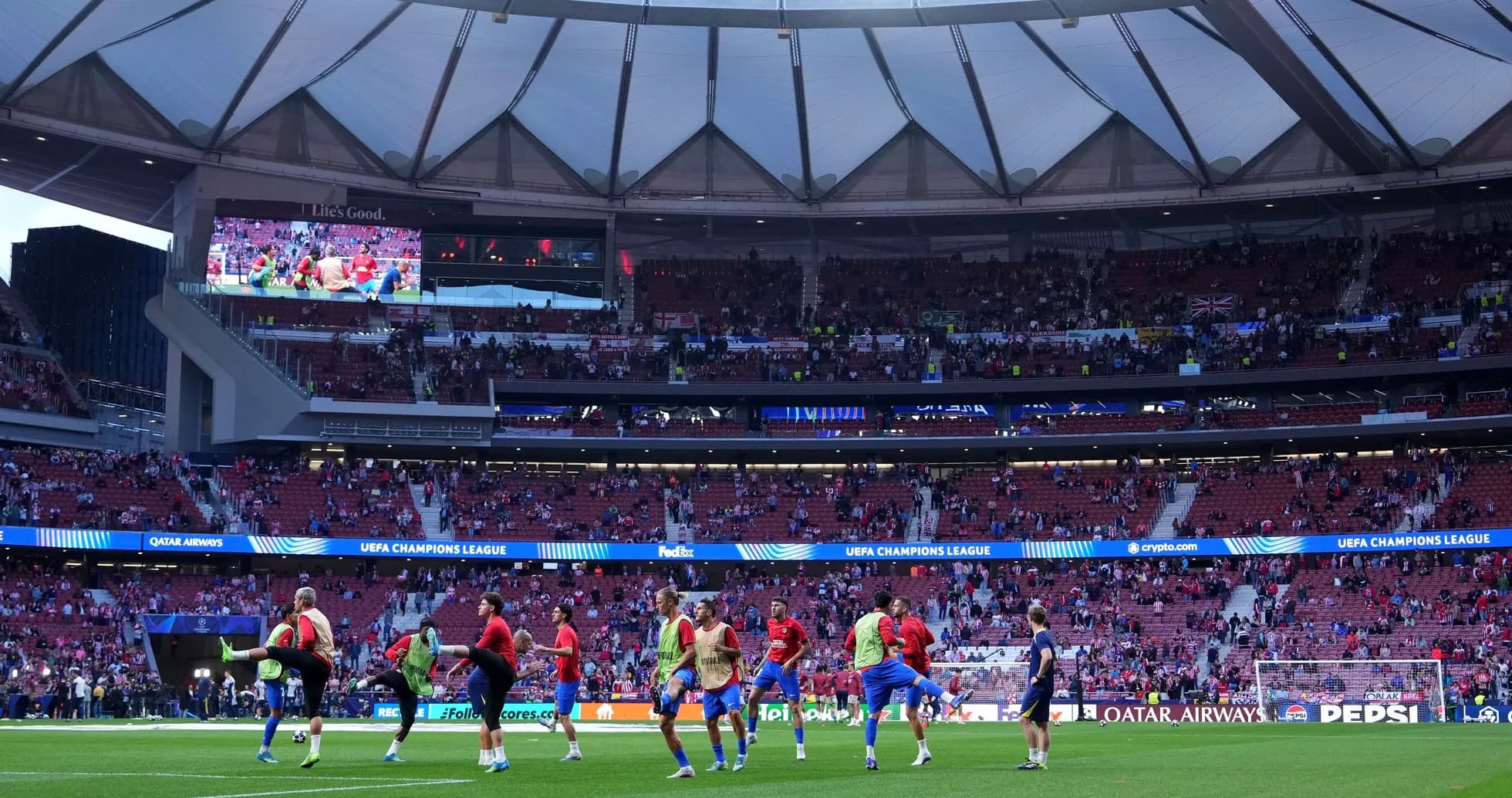 Players warming up on the pitch before UEFA match