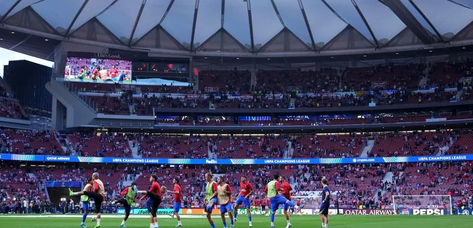 Players warming up on the pitch before UEFA match