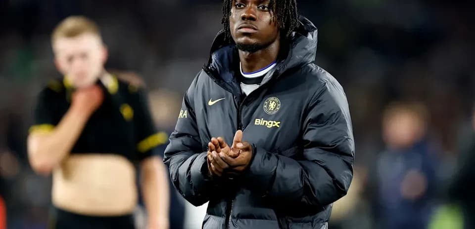 Player in Chelsea jacket clapping after match