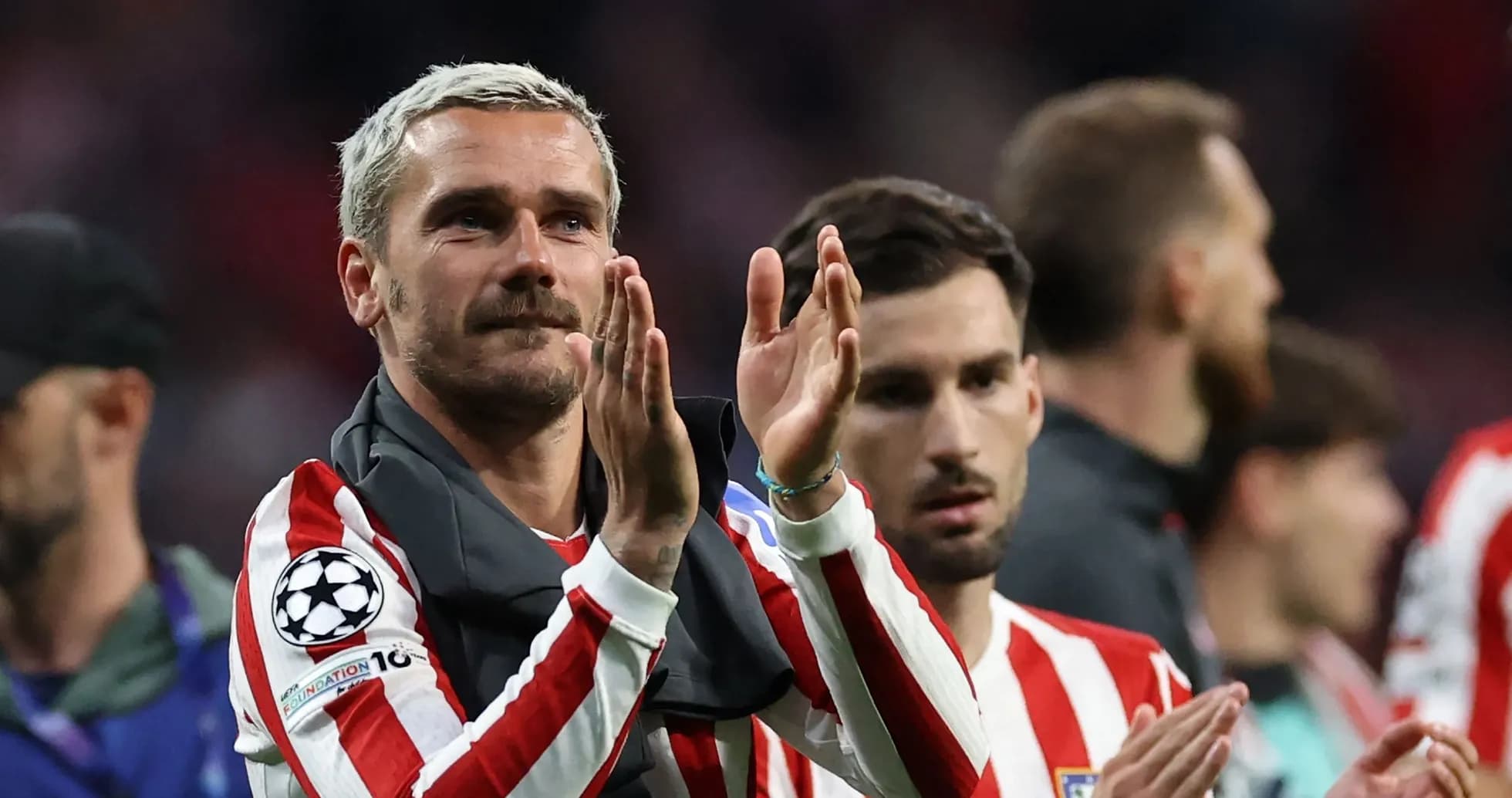 Player applauding fans after a match