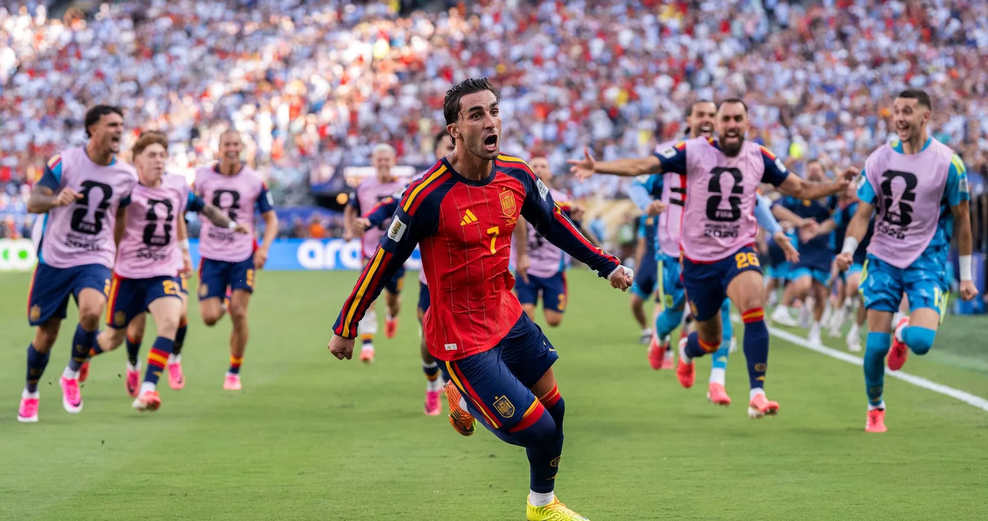 Spain player celebrating goal with teammates during match
