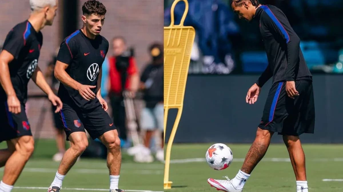 Two players training on the pitch with a ball