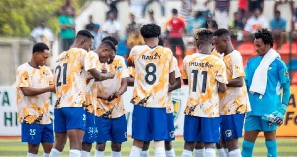 Players huddled together in team jerseys before match