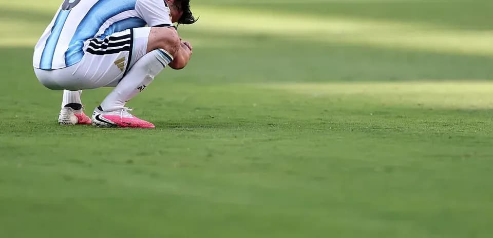 Player kneeling on field after match