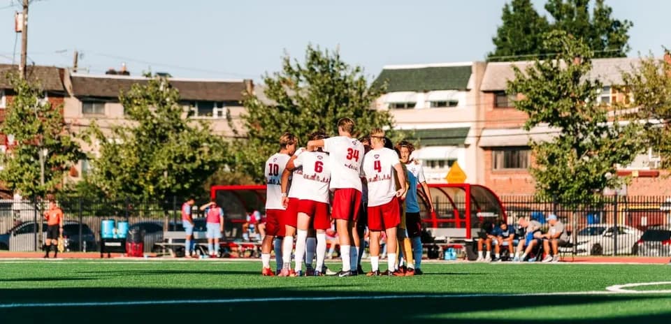Team huddled together on the soccer field