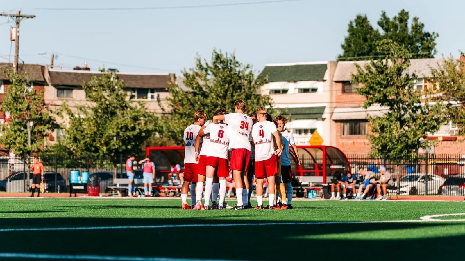 Team huddled together on the soccer field