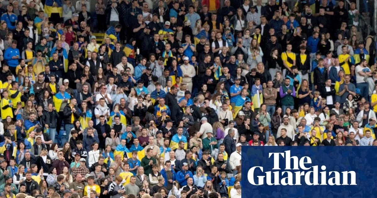 Crowd of fans cheering in stadium during match