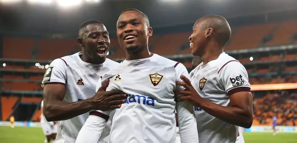 Players celebrating a goal in a football match