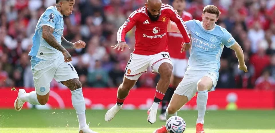 Players contesting for the ball during Manchester derby