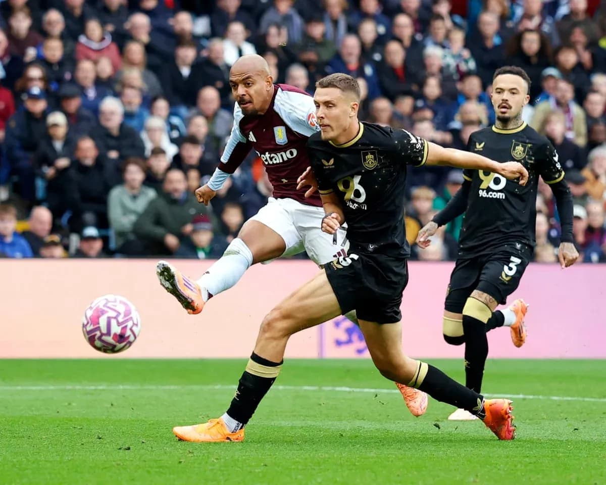 Aston Villa player shoots against Burnley defenders