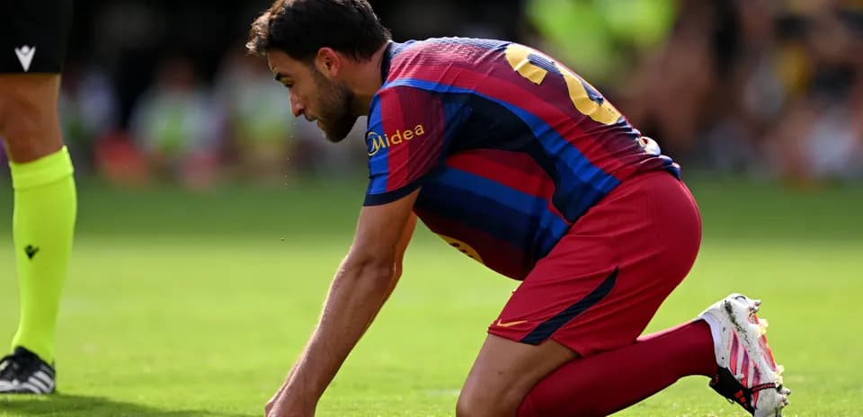 Player on knees during match on grass field