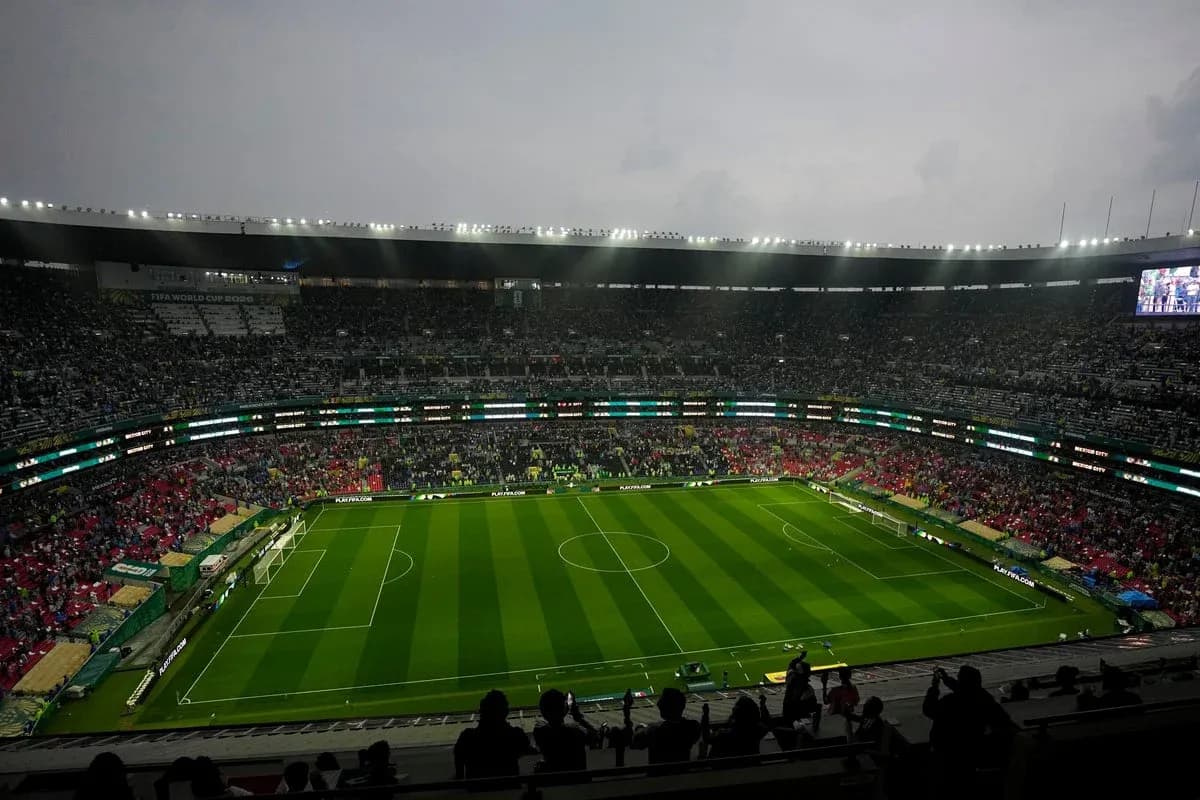 Empty stadium with green pitch before match