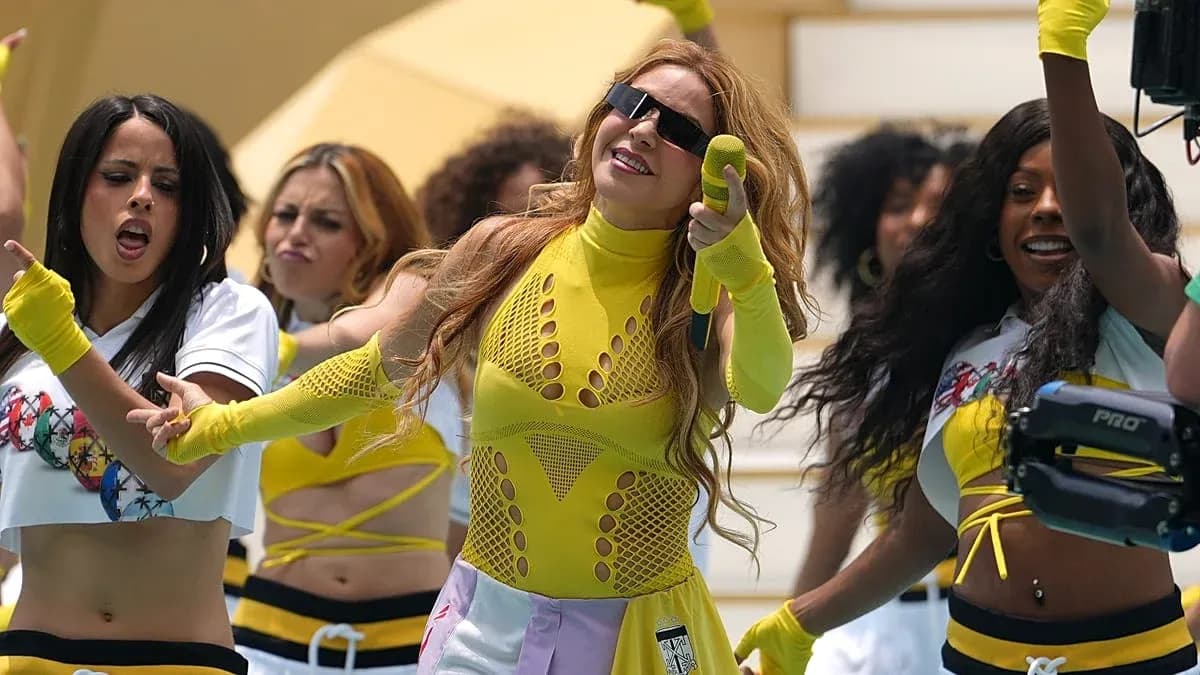 Performer singing with dancers during a lively performance