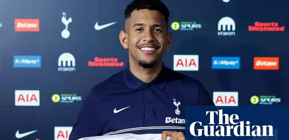 Player holding Tottenham Hotspur shirt at press conference
