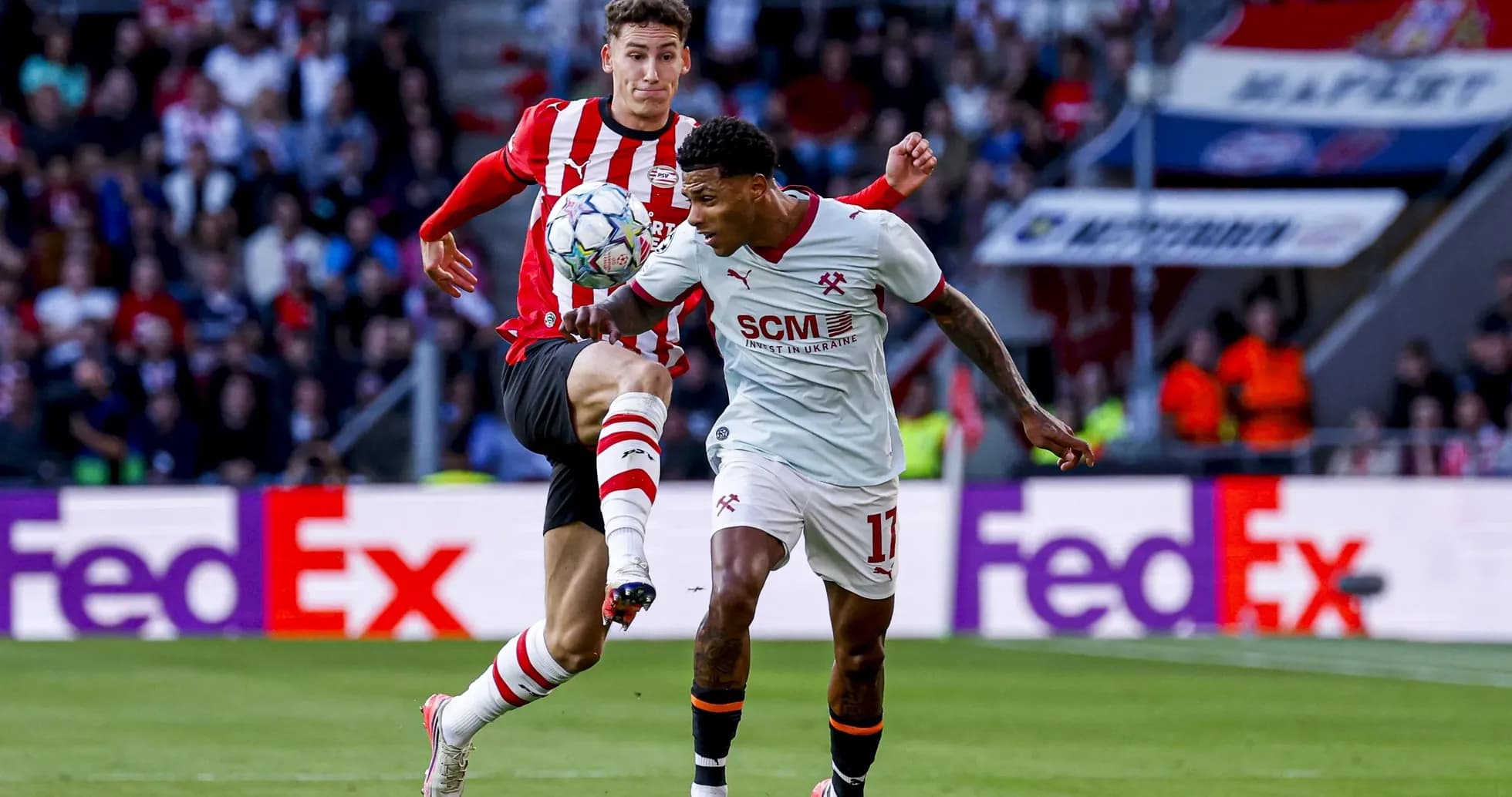 Two players contesting for the ball during match