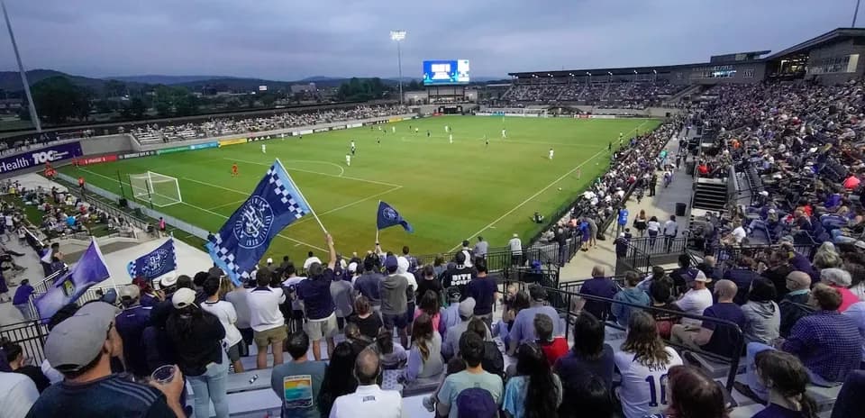 Fans cheering during Huntsville City match