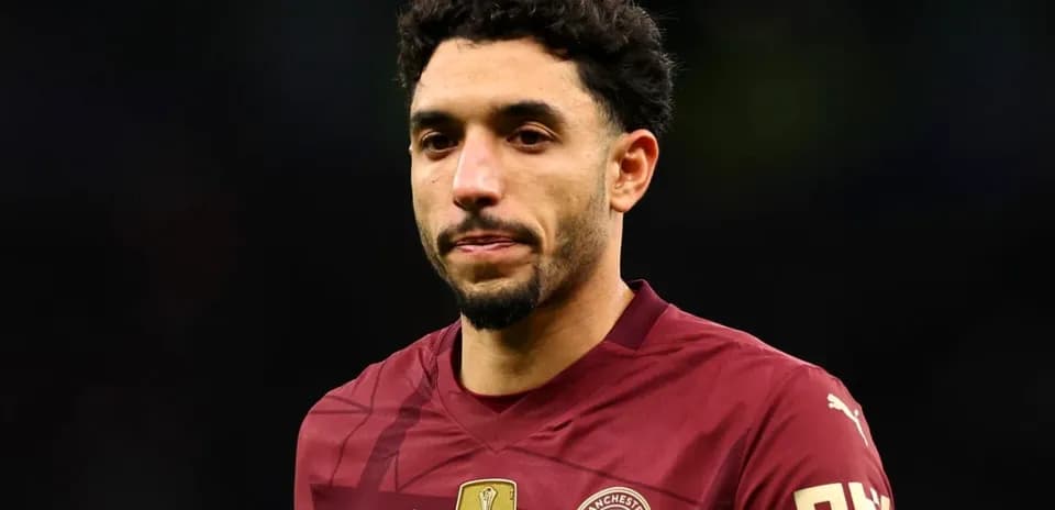 Player in maroon jersey during match at stadium