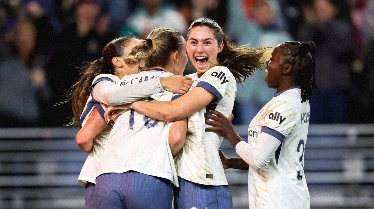 Players celebrating a goal during NWSL match