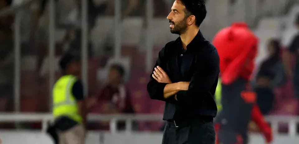 Coach observing match from sidelines during game