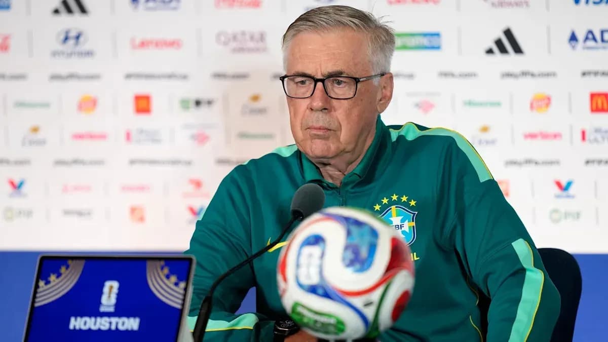Coach at press conference with soccer ball in front