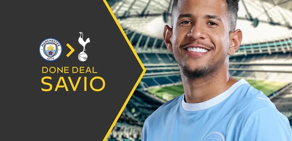 Savio smiling with Manchester City jersey background