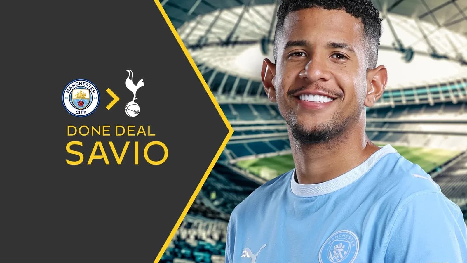 Savio smiling with Manchester City jersey background