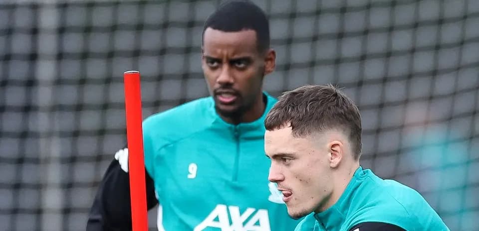 Two players training with equipment on the field