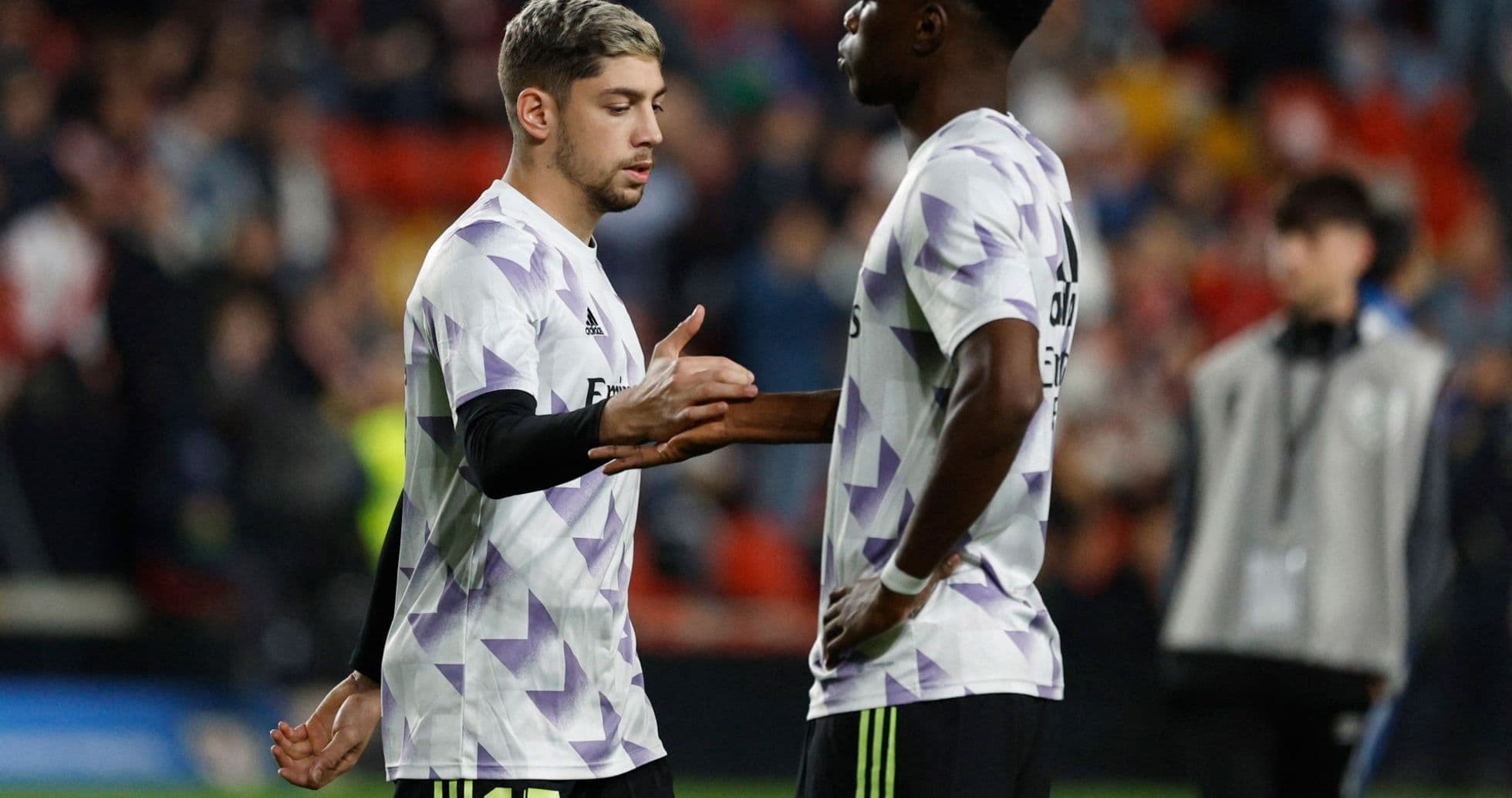 Two Real Madrid players interacting on the pitch