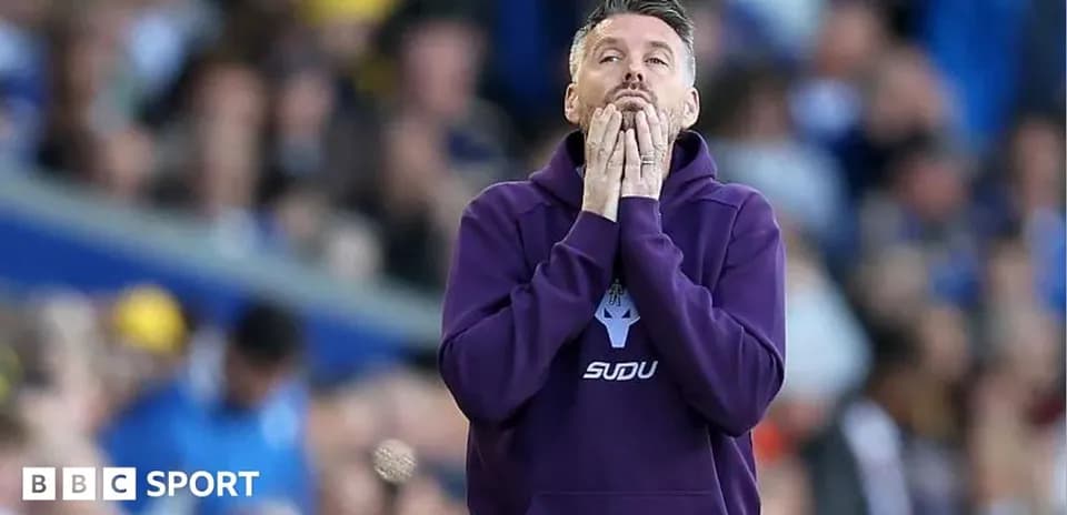 Coach with hands on face during match