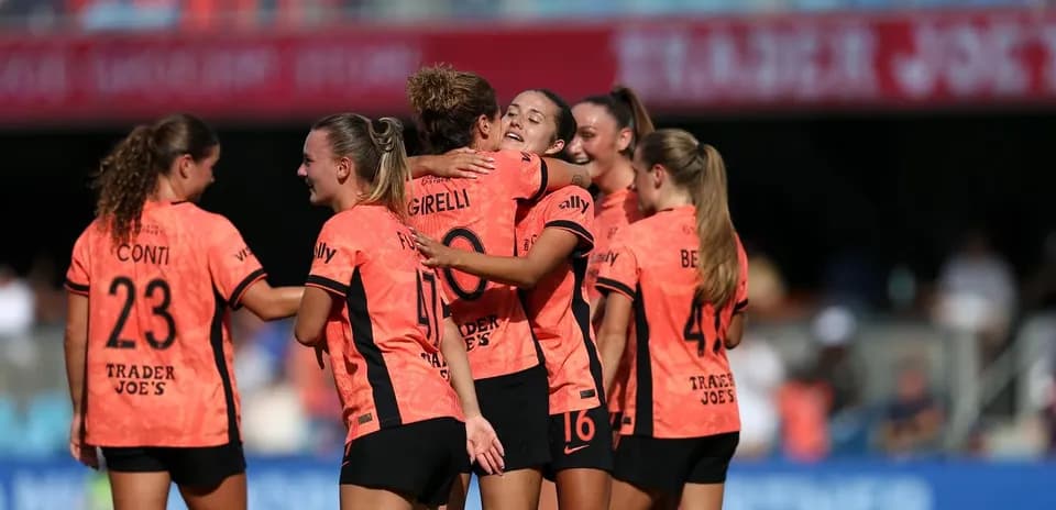 Players celebrating a goal during match
