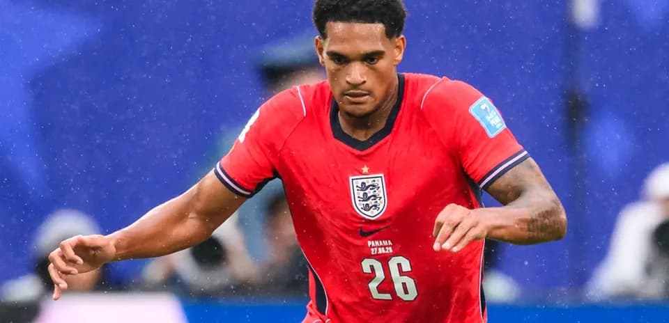 Player running during a football match wearing England kit